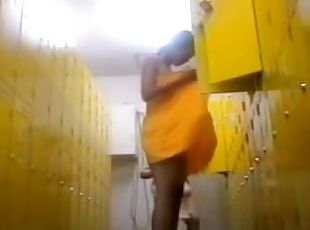 Tight Asian body is toweled after shower in dressing room