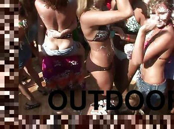 Party girls get topless and dance at a wild outdoor party