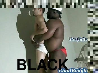 Black Giant bodybuilder poses & lift & carry a gay guy