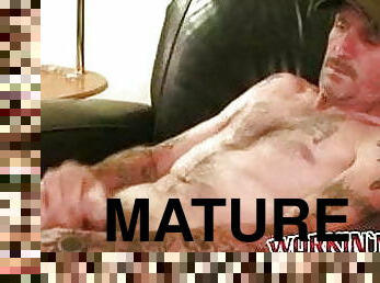 Tattooed mature amateur masturbates small cock and cums
