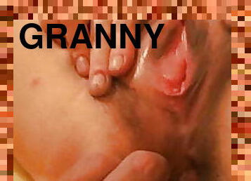 This horny granny masturbates her hairy pussy for me