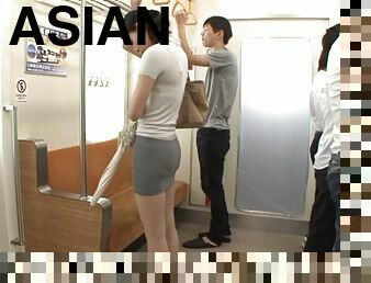 Asian slut sucks on two hard cocks in a subway