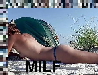 Sexy MILF tanning topless