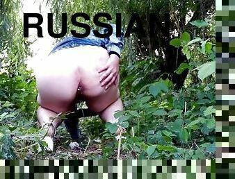 Russian mommy pissing outdoors with a butt plug in her ass