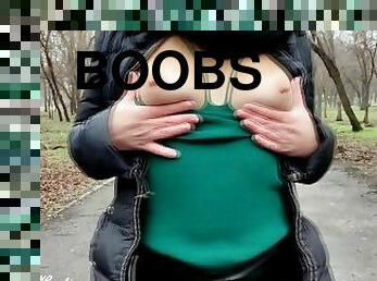 A girl with a beautiful booty walks in an autumn park in leather pants and sometimes shows her boobs