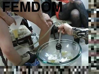 Femdom porn scene with three mistresses forcing a human toilet to drink their pee
