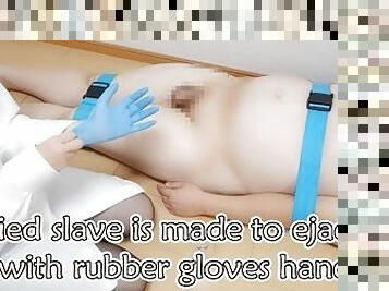 Tied up a slave and handjob with rubber gloves.