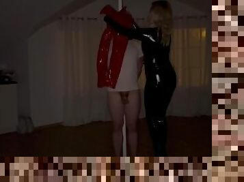 Woman in leather catsuit doing breathplay on slave